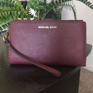 Burgundy Michael Kors smartphone wallet.